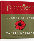 A square retail box for Poppies Luxury Airlaid Tablin Napkins, featuring a textured red top half with gold 'poppies' branding and a muted olive-green lower half with a large red poppy illustration and white text.