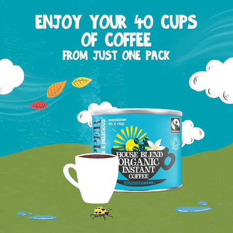 A stylized promotional graphic for House Blend Organic Instant Coffee. A blue coffee can with a Fairtrade logo sits on a green hill beside a white coffee cup, with the text 'ENJOY YOUR 40 CUPS OF COFFEE FROM JUST ONE PACK' above on a bright blue sky background with clouds and leaves.