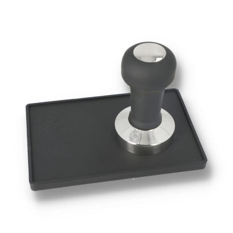 Coffee tamper with black rubber base and metal handle on a white background