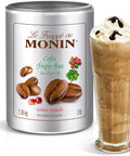 Le Frappe de Monin coffee frappe base canister with a glass of frappe on a white background