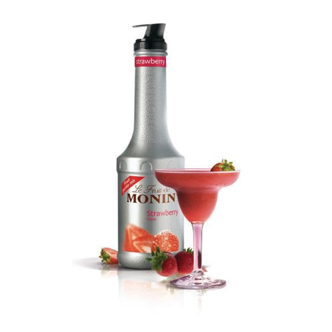 Monin strawberry syrup bottle with a strawberry-themed glass on a white background