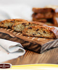 Biscotti on a wooden board with Pan Dècale logo at the bottom.
