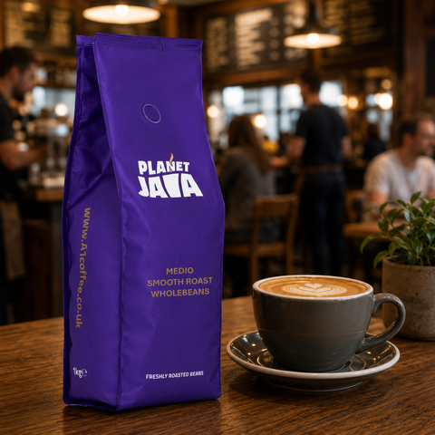 Purple Planet Java coffee bag with a cup of coffee on a wooden table in a café setting.