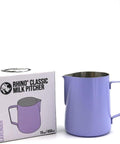 A lavender purple stainless steel milk pitcher next to its product packaging box, which is labeled 'RHINO CLASSIC MILK PITCHER' and 'LAVENDER'.