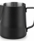 Matte black metal milk pitcher with a curved handle and integrated pour spout, shown on a clean white background.