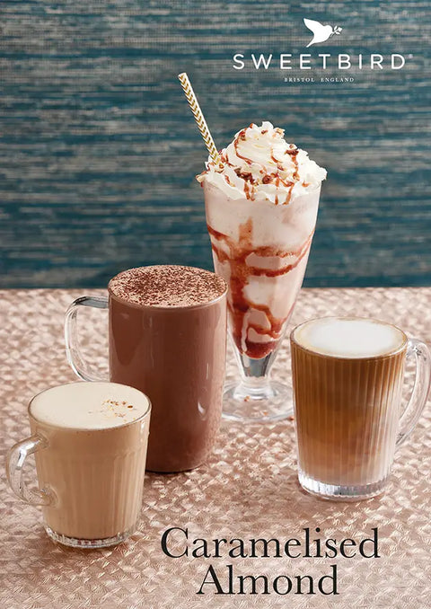 Three coffee drinks with whipped cream and a straw on a textured surface, featuring the Sweetbird brand.