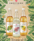 Three bottles of Sweetbird tropical fruit syrups on a leafy background