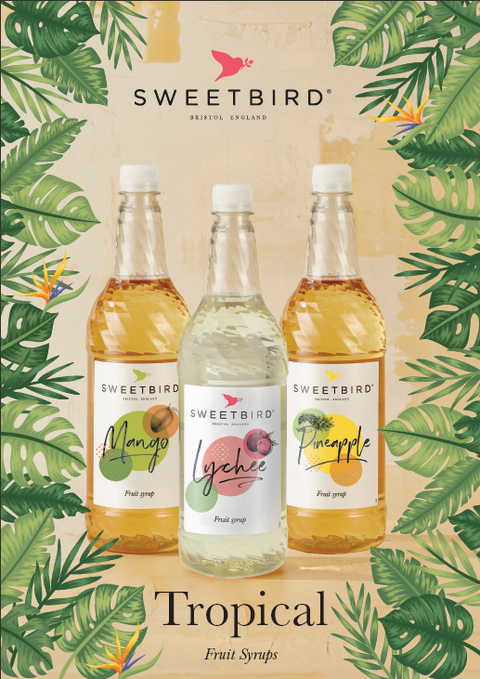 Three bottles of Sweetbird tropical fruit syrups on a leafy background