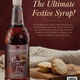 Bottle of Sweetbird Mince Pie Syrup with mince pies on a wooden board against a brown background.